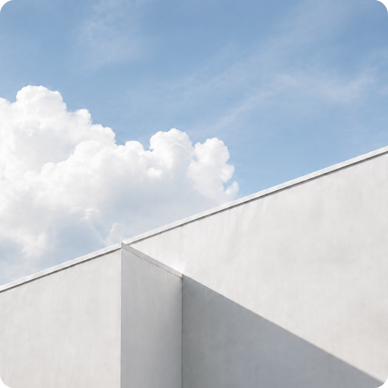 Modern white architecture against a clear blue sky